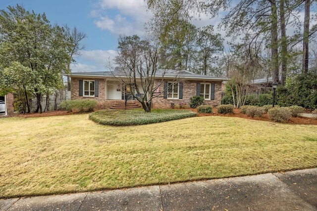 ranch-style home with brick siding and a front lawn