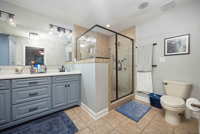 full bathroom featuring a stall shower, a textured ceiling, a ceiling fan, and double vanity