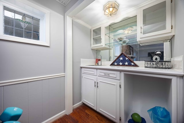 kitchen featuring glass insert cabinets, dark wood-type flooring, white cabinets, and light countertops