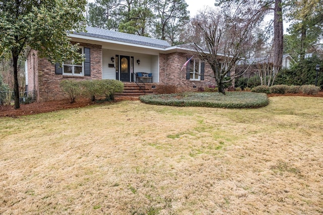 ranch-style house with a front yard, a porch, and brick siding