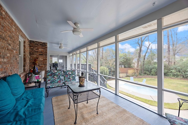 unfurnished sunroom featuring a ceiling fan