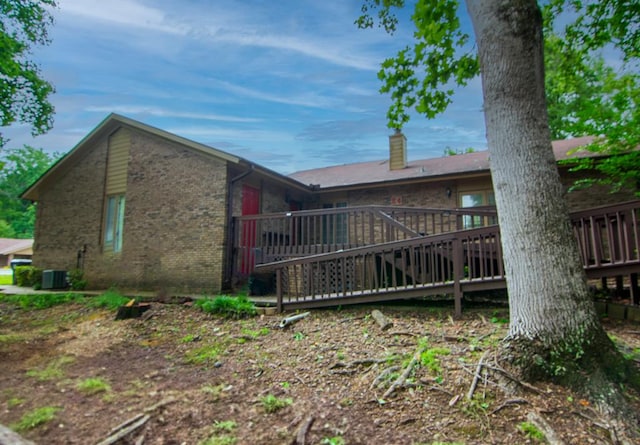 4200 Bridgecrest Dr Unit E4, Phenix City, AL 36867 - view of side of property featuring a deck, brick siding, a chimney, and central AC