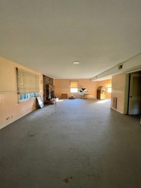 basement with a fireplace and a wealth of natural light