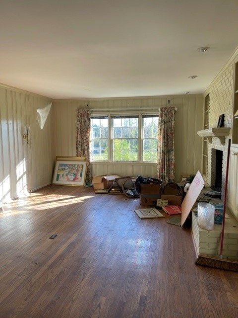 misc room with dark hardwood / wood-style floors and a brick fireplace