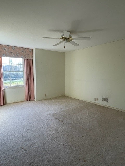 unfurnished room with ceiling fan and carpet floors