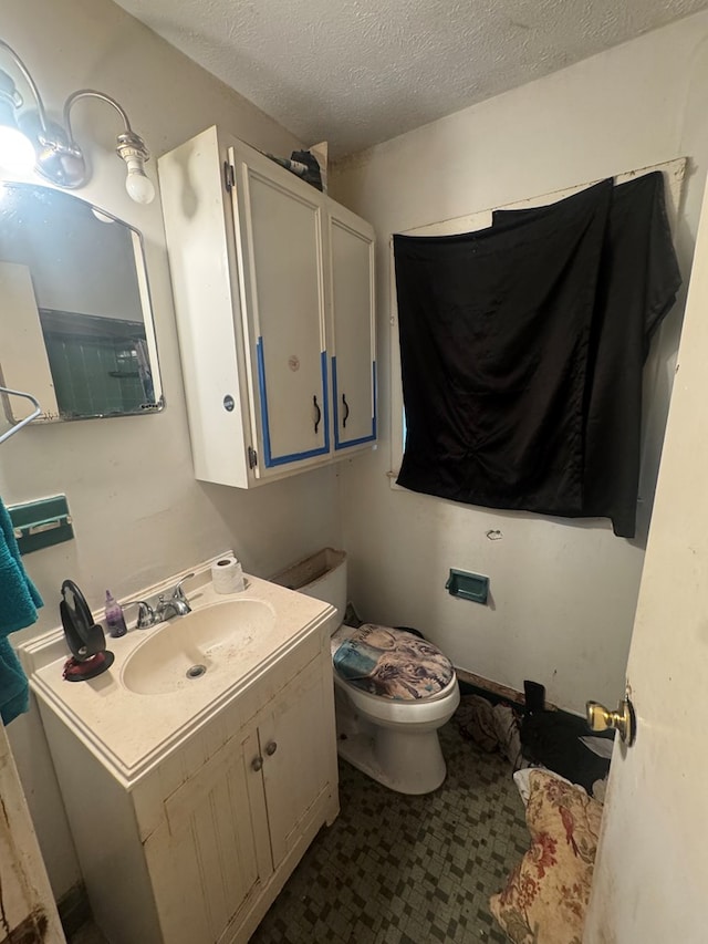 322 48th St, Columbus, GA 31904 - bathroom with vanity and a textured ceiling
