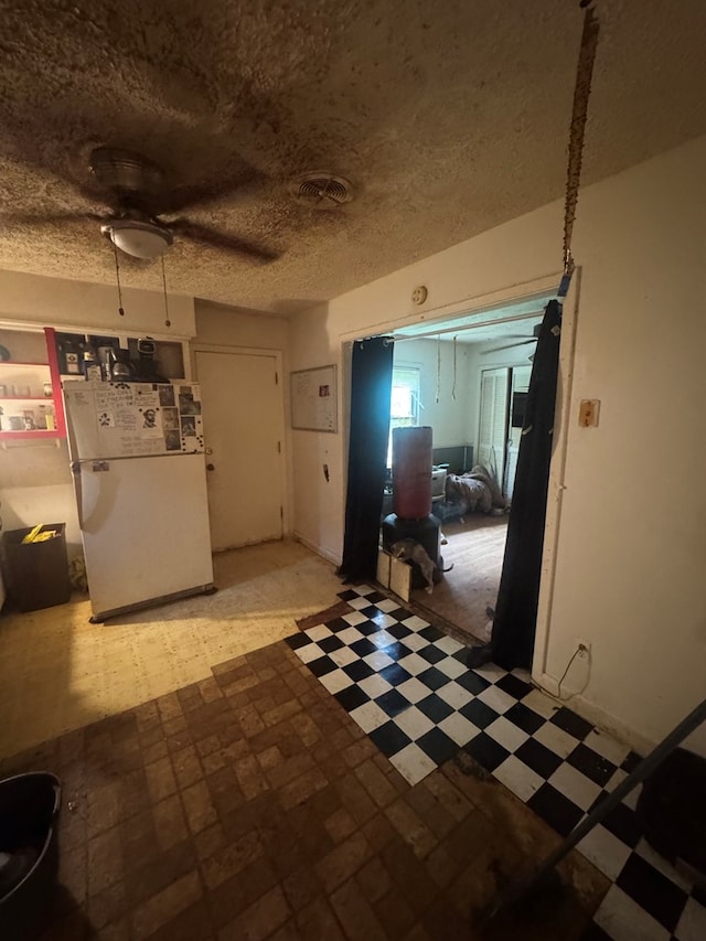 322 48th St, Columbus, GA 31904 - kitchen featuring tile patterned floors, a textured ceiling, a ceiling fan, and freestanding refrigerator