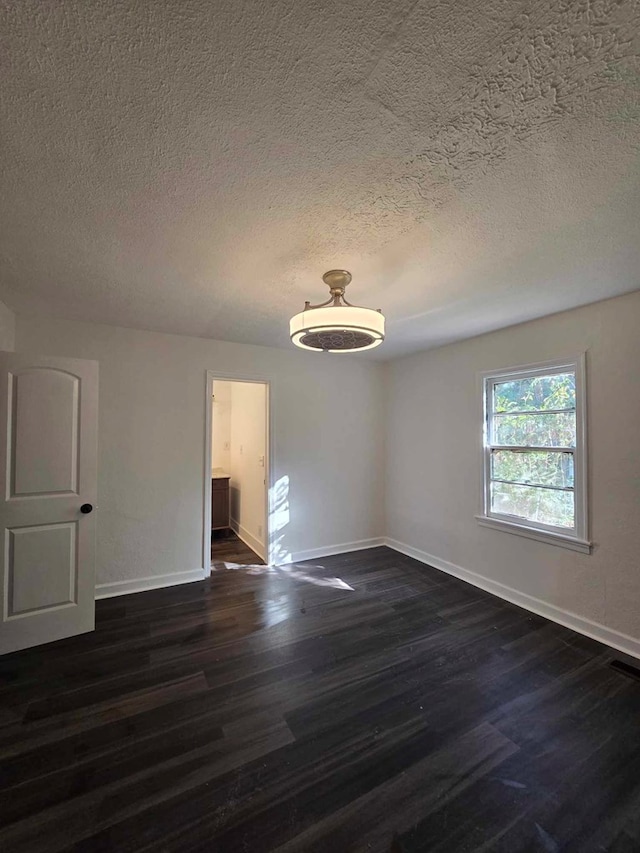 2514 Avalon Rd, Columbus, GA 31907 - spare room with dark wood-style floors and a textured ceiling