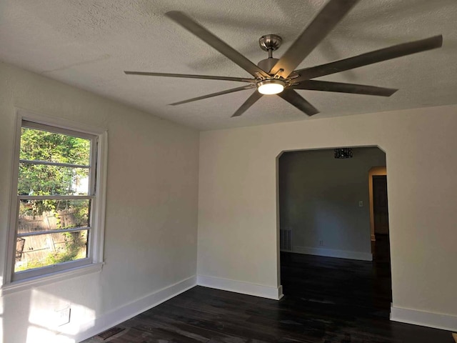 2514 Avalon Rd, Columbus, GA 31907 - spare room featuring arched walkways, a textured ceiling, dark wood-style floors, and a ceiling fan