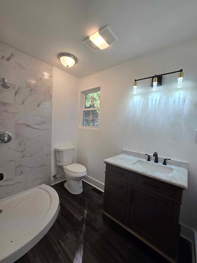 2514 Avalon Rd, Columbus, GA 31907 - full bath with vanity, a tile shower, and wood finished floors