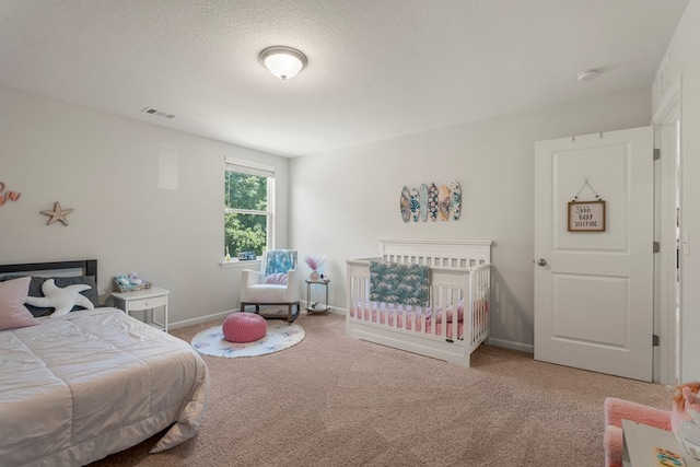 10 Red Maple St, Phenix City, AL 36869 - carpeted bedroom featuring baseboards and a textured ceiling