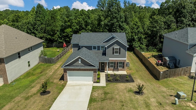 10 Red Maple St, Phenix City, AL 36869 - traditional home featuring brick siding, concrete driveway, an attached garage, and a fenced backyard