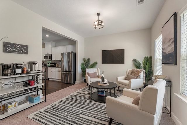10 Red Maple St, Phenix City, AL 36869 - living room featuring dark colored carpet and a chandelier