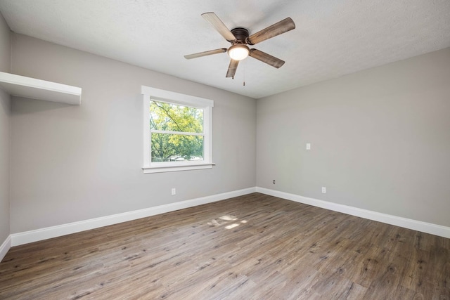 spare room featuring a textured ceiling, hardwood / wood-style flooring, and ceiling fan