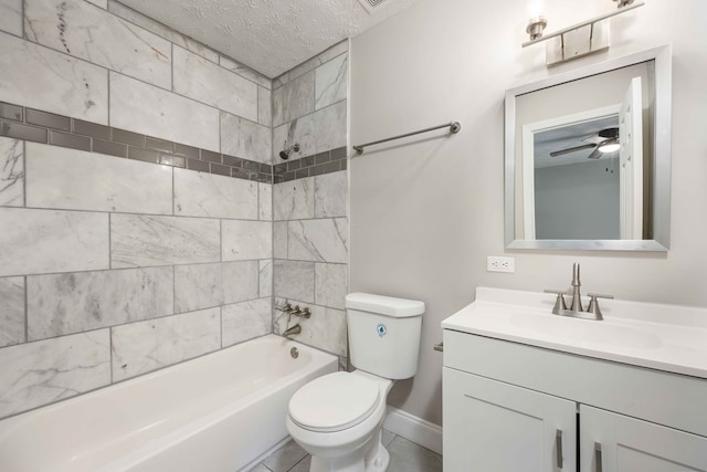 full bathroom featuring vanity, a textured ceiling, tiled shower / bath combo, ceiling fan, and toilet