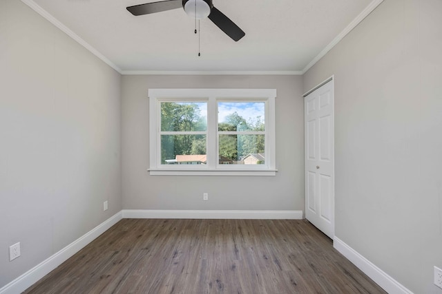 unfurnished bedroom with dark hardwood / wood-style floors, ceiling fan, and ornamental molding