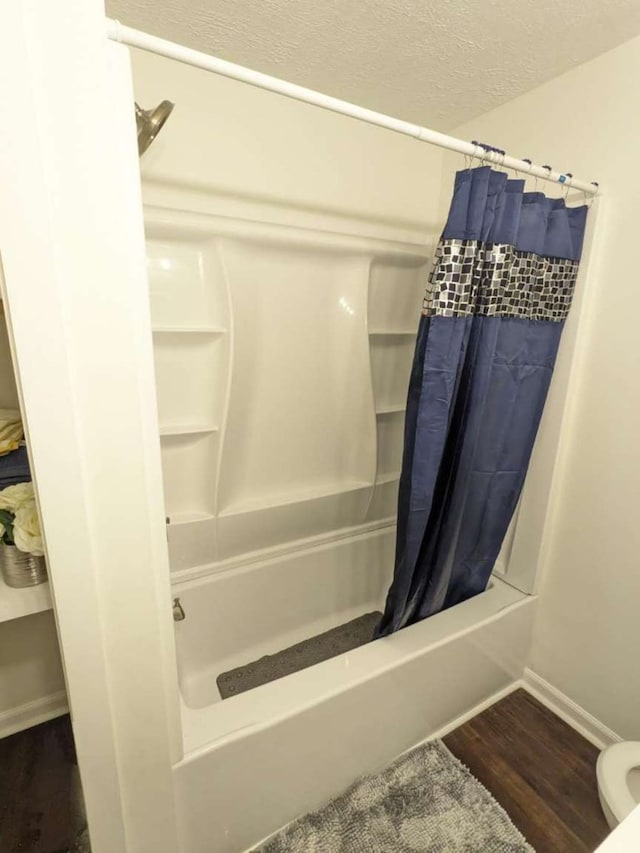 bathroom featuring shower / bath combination with curtain and hardwood / wood-style flooring