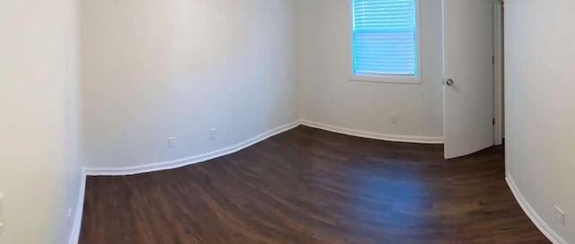 empty room featuring dark hardwood / wood-style flooring