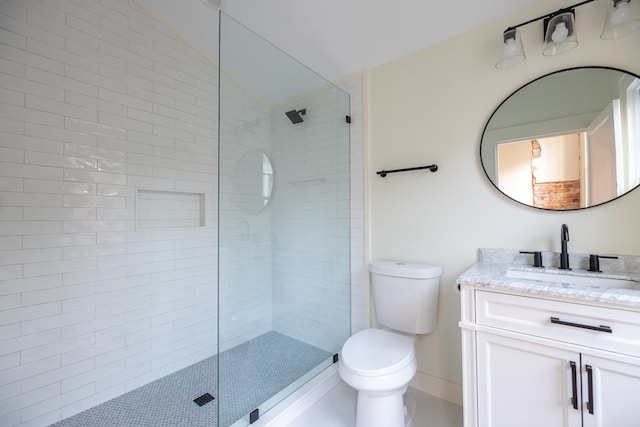 bathroom featuring tile patterned floors, vaulted ceiling, tiled shower, toilet, and vanity