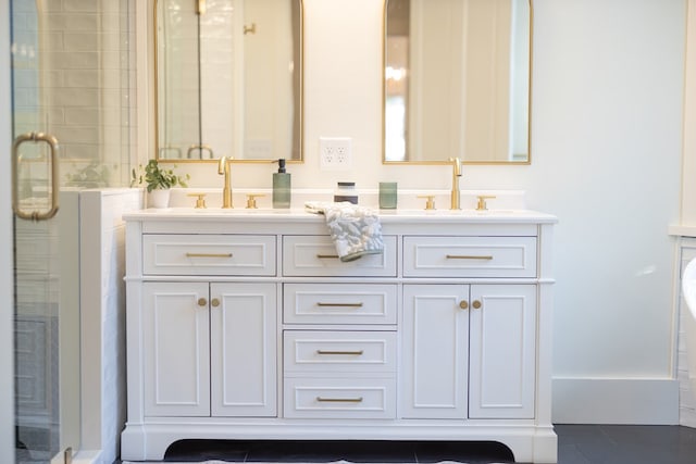 bathroom featuring tile patterned flooring, vanity, and an enclosed shower