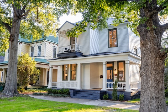 view of front of property with a balcony and a porch