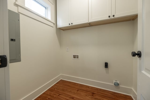 laundry room featuring hardwood / wood-style floors, electric dryer hookup, cabinets, electric panel, and hookup for a washing machine