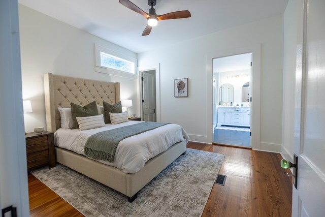 bedroom with hardwood / wood-style floors, connected bathroom, and ceiling fan