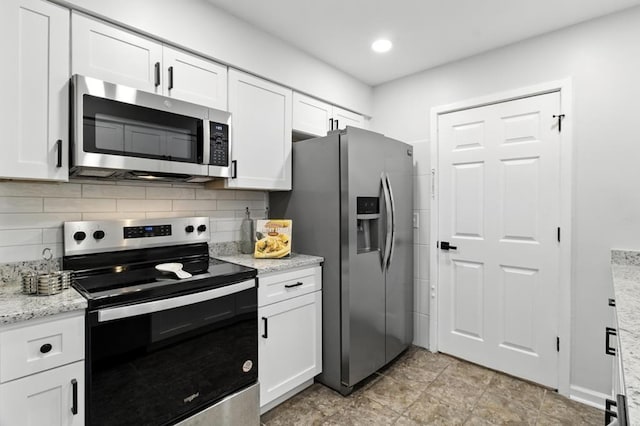 813 Wright Dr, Columbus, GA 31907 - kitchen with stainless steel appliances, white cabinets, and decorative backsplash