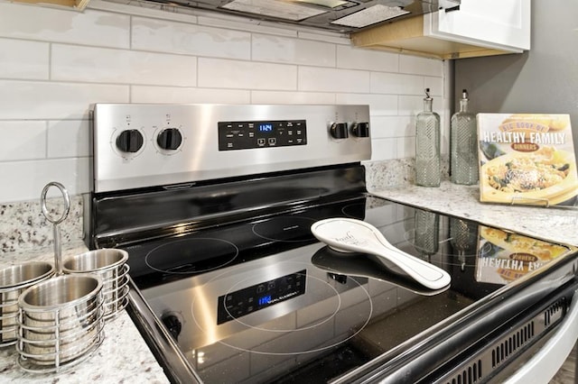 813 Wright Dr, Columbus, GA 31907 - kitchen view of electric range, backsplash, and light stone counters