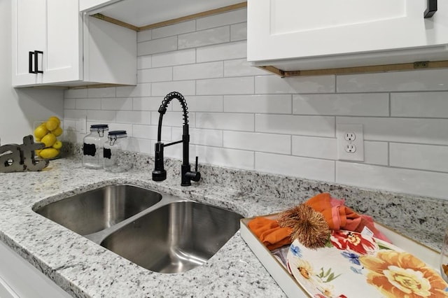 813 Wright Dr, Columbus, GA 31907 - kitchen view of white cabinetry, tasteful backsplash, and light stone counters