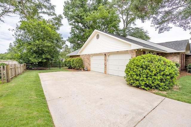6909 Trapper Way, Midland, GA 31820 - view of home's exterior with concrete driveway, brick siding, an attached garage, and a shingled roof