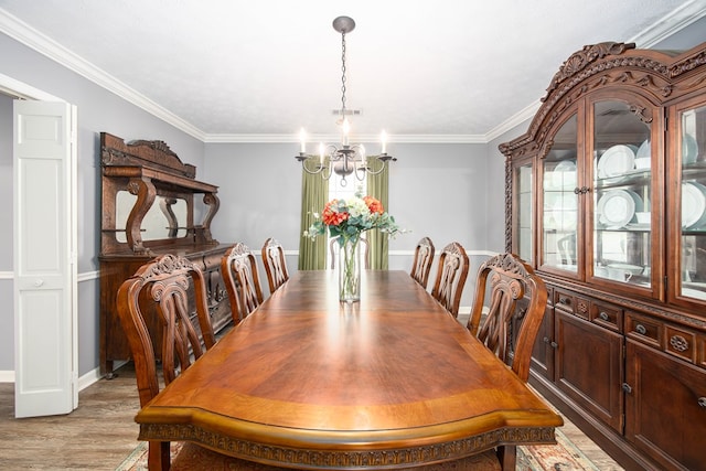 6909 Trapper Way, Midland, GA 31820 - dining room featuring a chandelier, ornamental molding, and light wood-style flooring