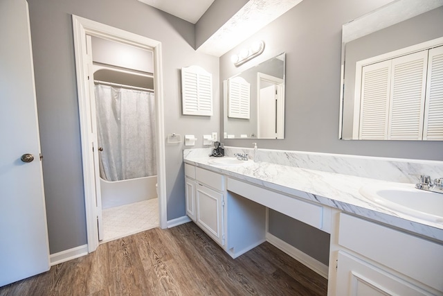 6909 Trapper Way, Midland, GA 31820 - bathroom with double vanity, wood finished floors, and shower / bath combo with shower curtain