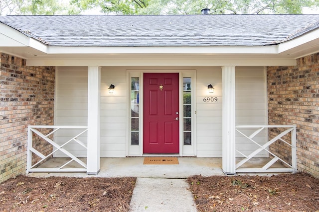 6909 Trapper Way, Midland, GA 31820 - property entrance featuring a shingled roof, brick siding, and a porch