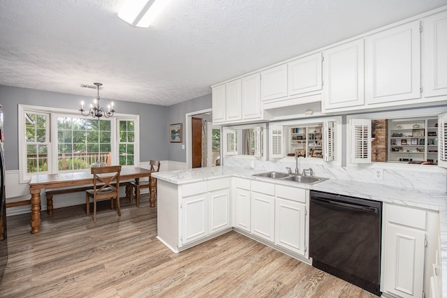 6909 Trapper Way, Midland, GA 31820 - kitchen featuring dishwasher, a peninsula, light wood-type flooring, white cabinets, and a textured ceiling