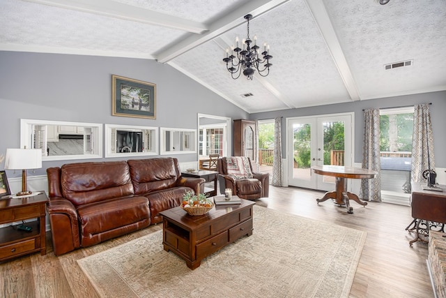 6909 Trapper Way, Midland, GA 31820 - living room featuring wood finished floors, french doors, a chandelier, and a textured ceiling