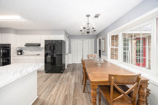 6909 Trapper Way, Midland, GA 31820 - dining area featuring a chandelier and light wood finished floors