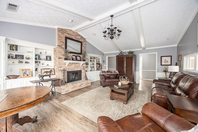 6909 Trapper Way, Midland, GA 31820 - living room with wood finished floors, a chandelier, and a fireplace