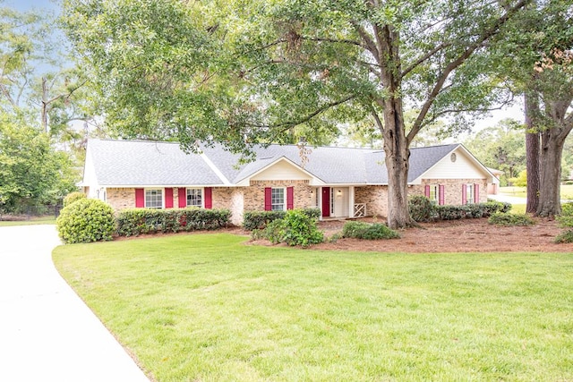 6909 Trapper Way, Midland, GA 31820 - view of front facade with a front yard and brick siding