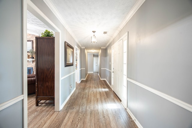 6909 Trapper Way, Midland, GA 31820 - hall featuring wood finished floors, a textured ceiling, and crown molding