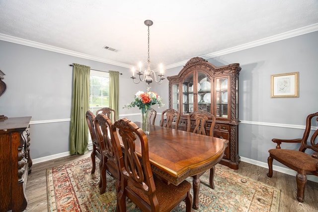 6909 Trapper Way, Midland, GA 31820 - dining room featuring a chandelier, wood finished floors, and ornamental molding