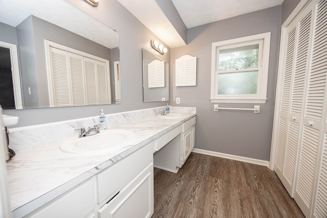 6909 Trapper Way, Midland, GA 31820 - full bath with a closet, double vanity, and wood finished floors