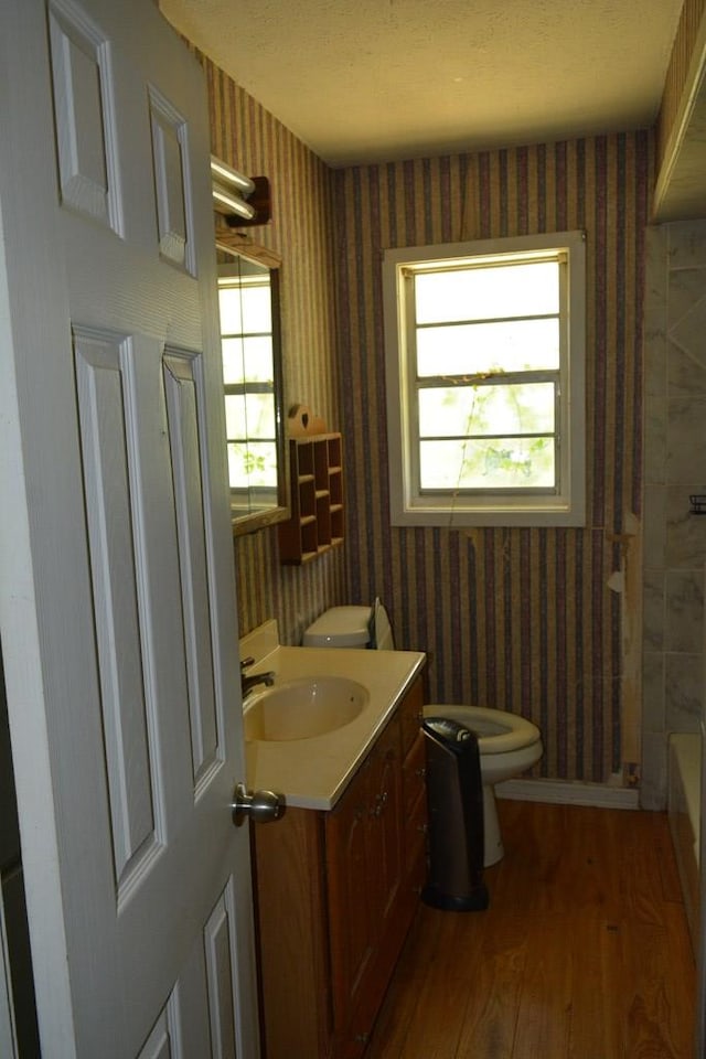 5137 Burbank St, Columbus, GA 31907 - bathroom with wood-type flooring, vanity, wallpapered walls, a tub to relax in, and a shower