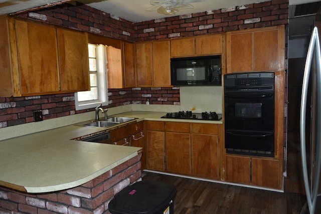 5137 Burbank St, Columbus, GA 31907 - kitchen with black appliances, a warming drawer, light countertops, brown cabinets, and a peninsula