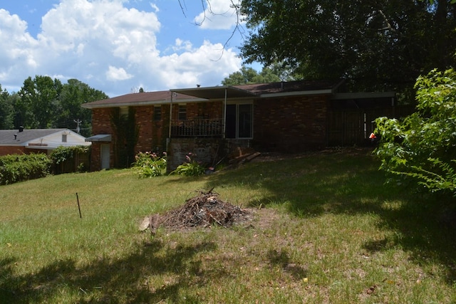 5137 Burbank St, Columbus, GA 31907 - back of house featuring a lawn, brick siding, and a carport