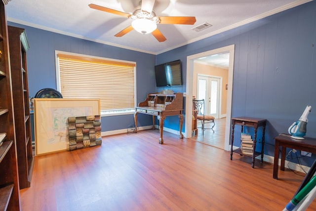 interior space with wood finished floors, visible vents, and crown molding