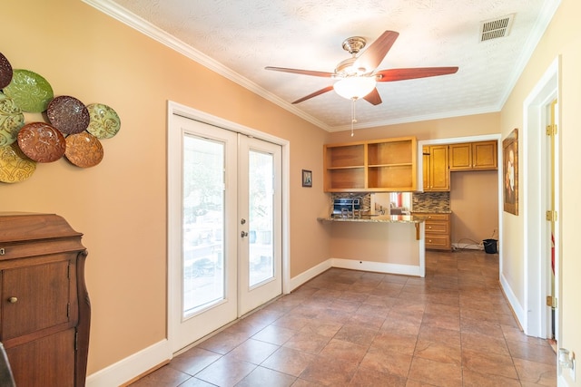 kitchen featuring a peninsula, visible vents, open shelves, and french doors