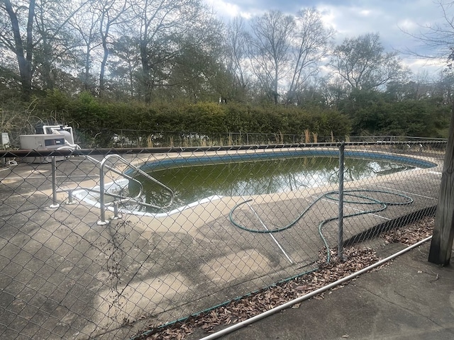 view of swimming pool featuring a fenced in pool and fence