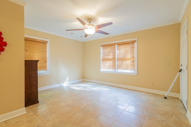 empty room featuring baseboards, ornamental molding, and a ceiling fan