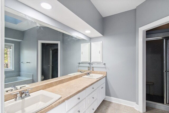 full bathroom with tile patterned flooring, shower with separate bathtub, vanity, and toilet